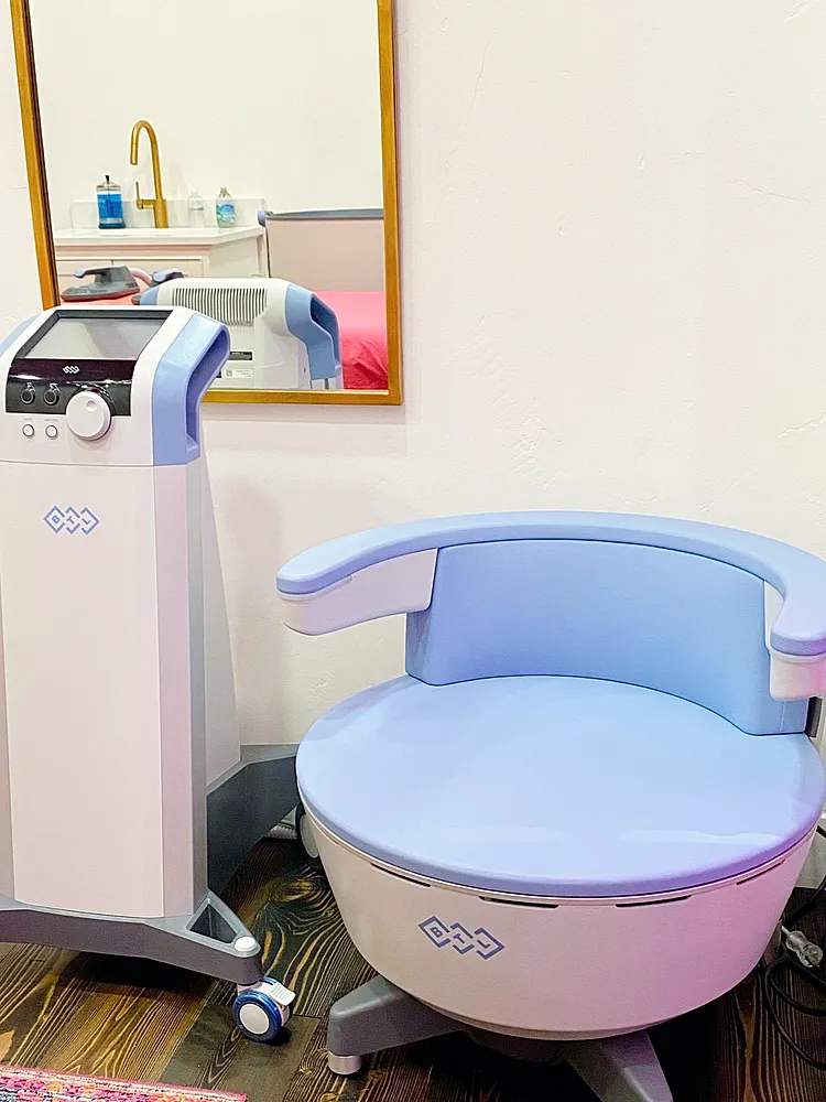 Medical equipment and therapy chair in room.