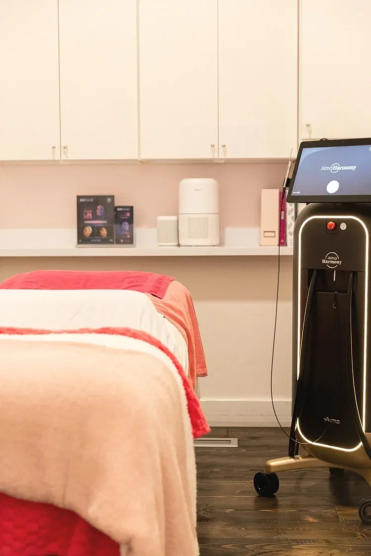 Aesthetic treatment room with equipment and beds.