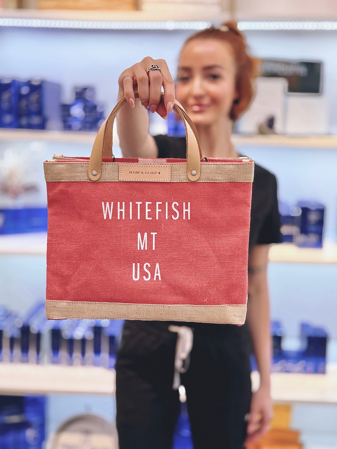 Person holding a Whitefish MT USA tote bag.
