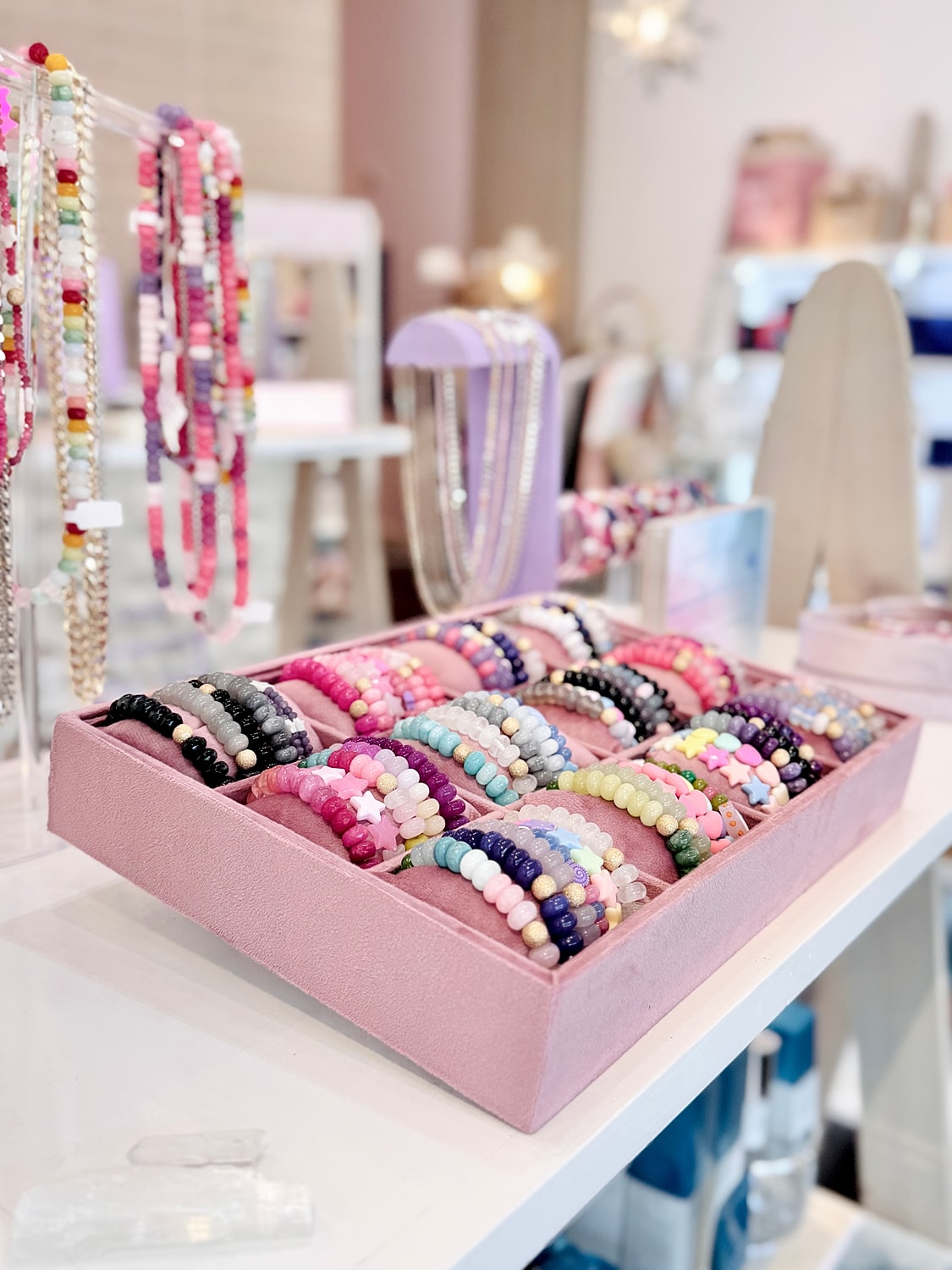 Colorful bracelets arranged in a display box.