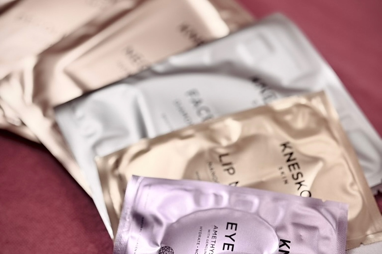 Assorted skincare mask packages on a surface.