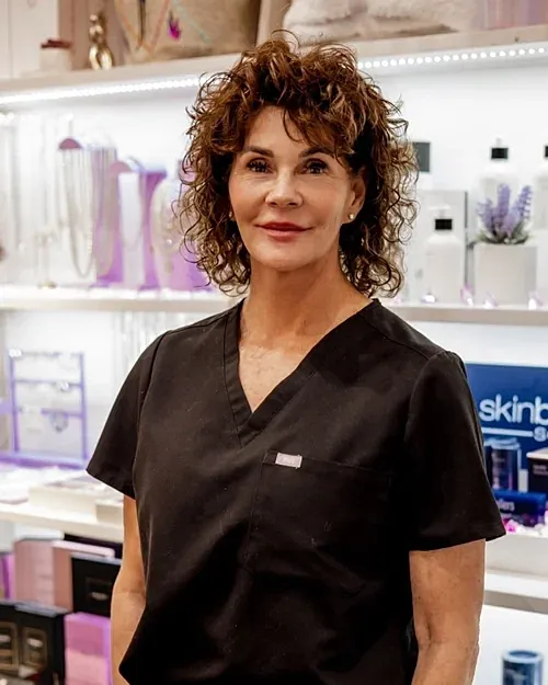 Woman in black scrubs in a retail setting.
