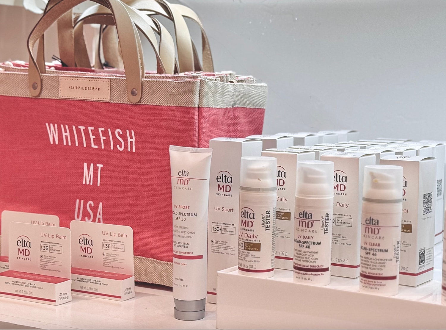 Skincare products and tote bag display arrangement.