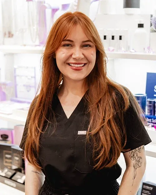 Smiling woman in a black uniform.