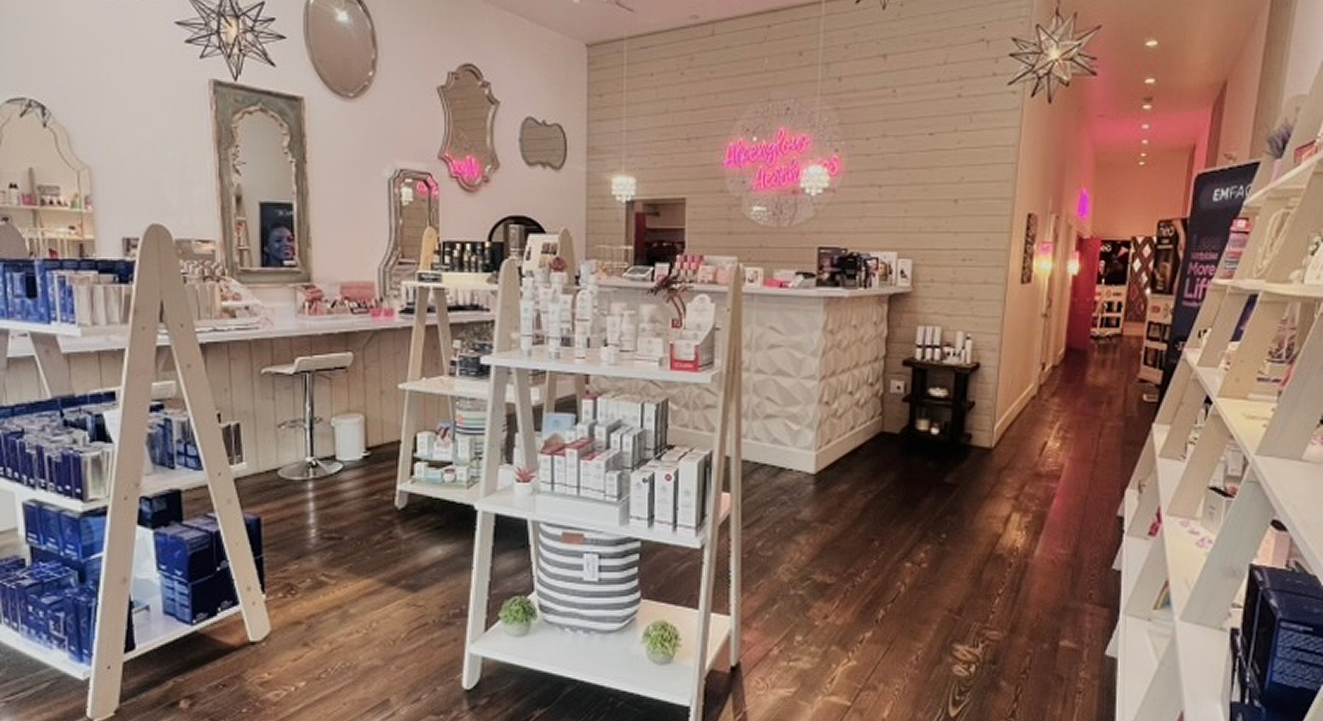 Bright waiting area with pink chairs and decor.