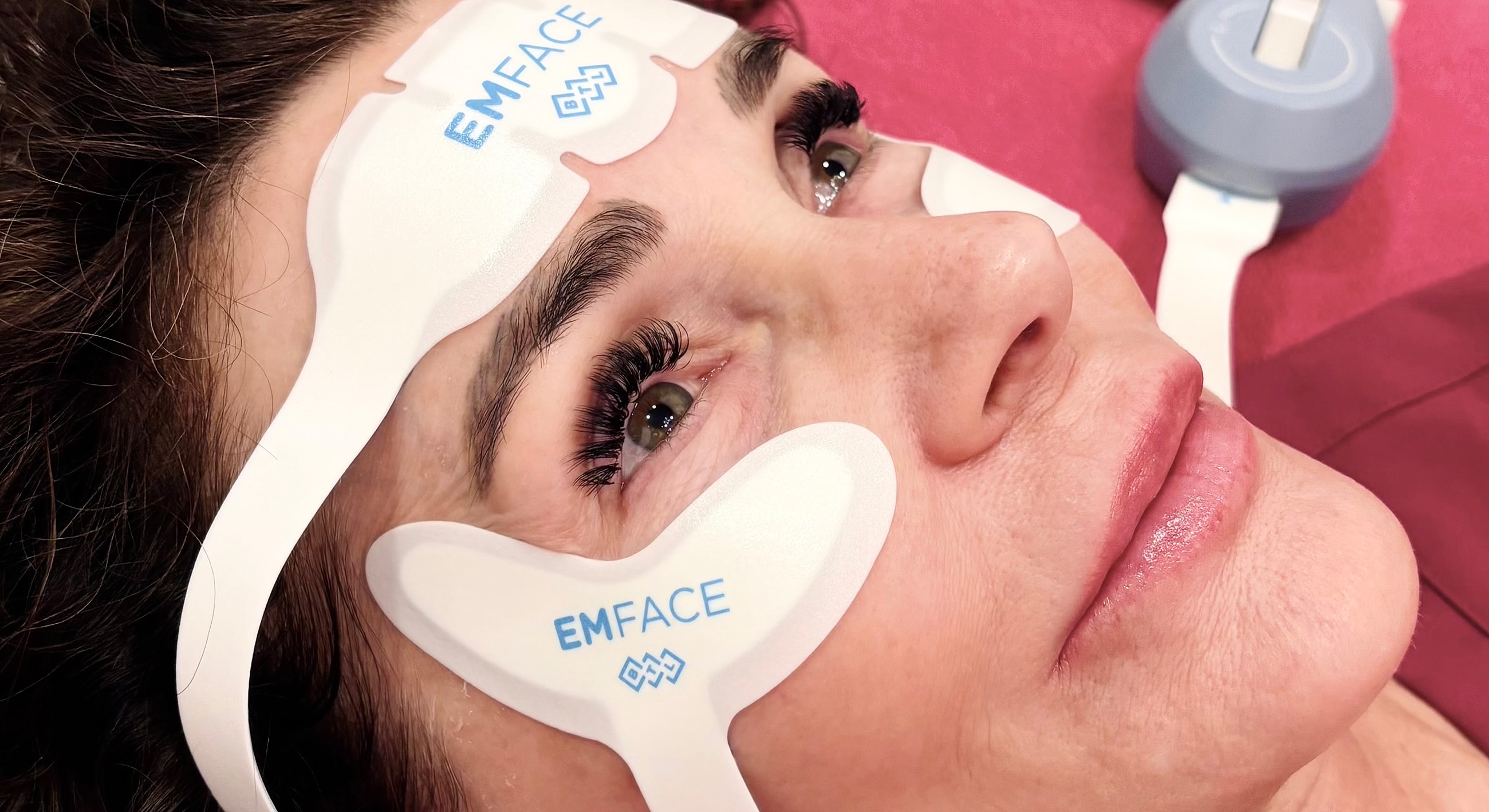 Whitefish EMFACE model receiving facial treatment procedure.