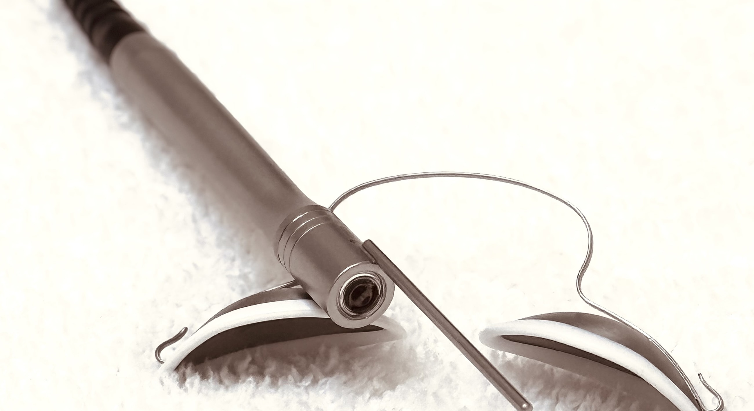 Pen and clasp tool on a soft surface