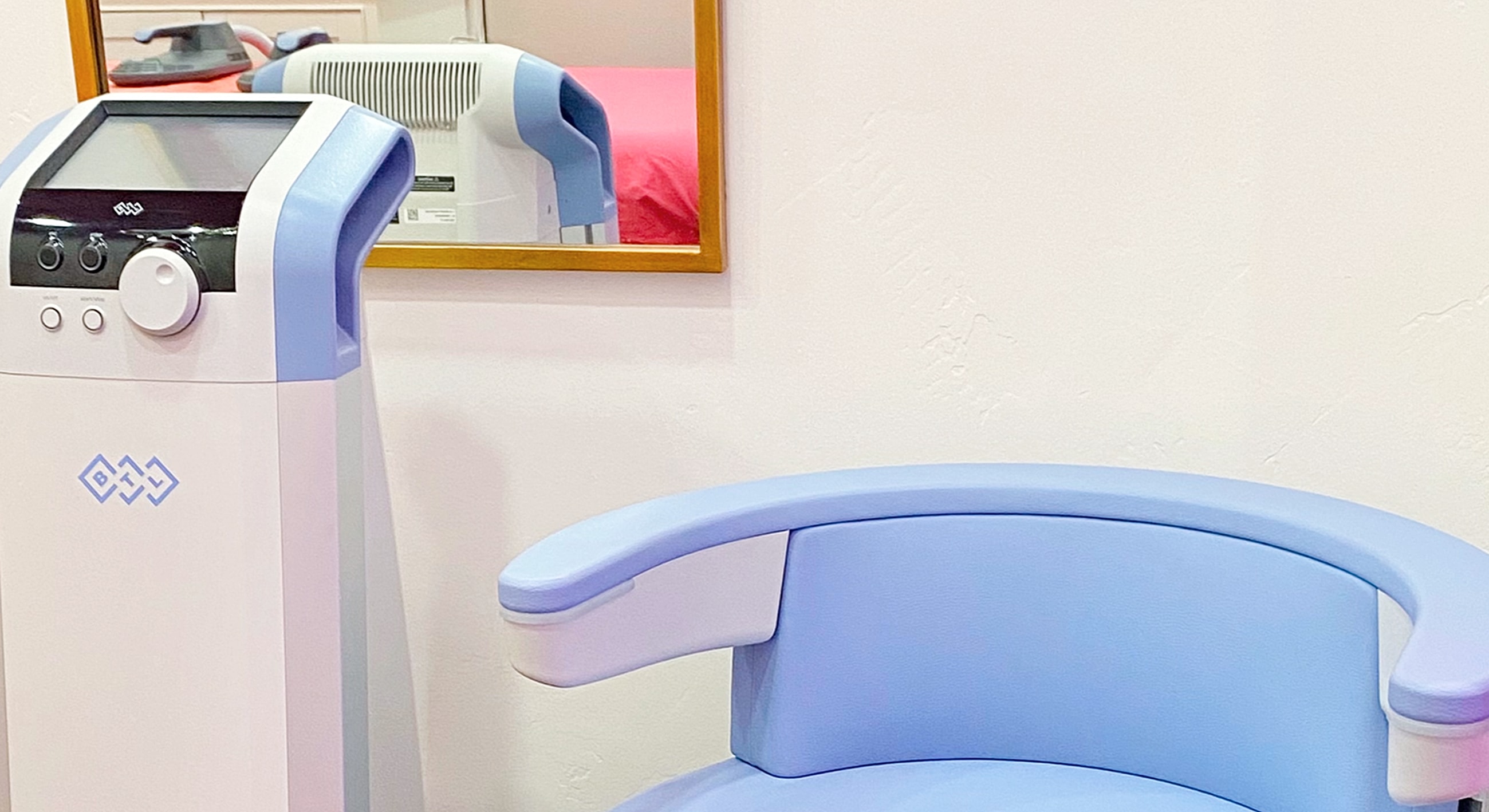 Medical equipment and chair in clinical setting.